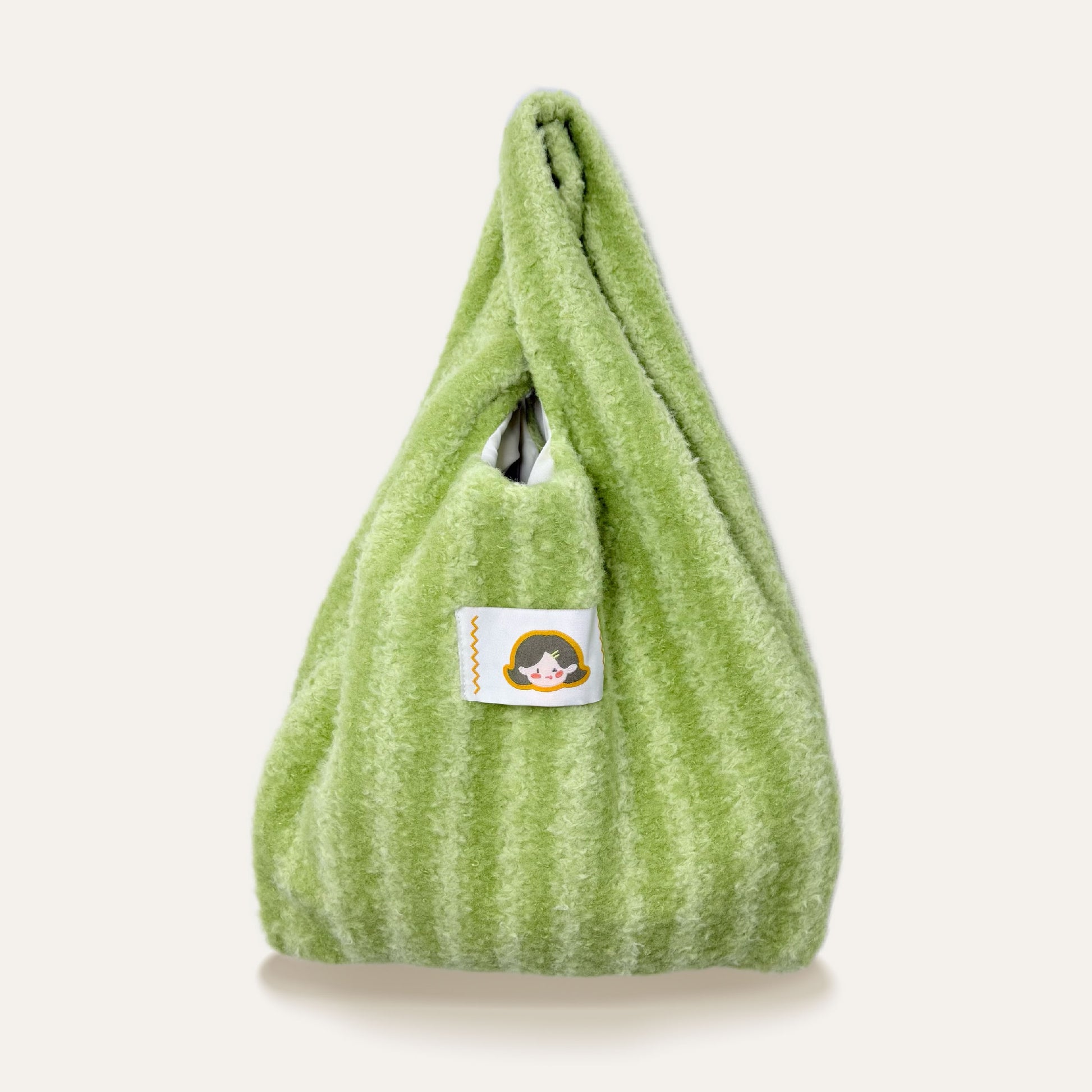 The Little Hue Green Striped Furry Designer Canvas Tote Bag is a perfect blend of playful charm and bold style, inspired by Little Hue’s colorful, confident personality. The vibrant green stripes evoke freshness, growth, and a sense of adventure, while the soft, furry texture adds a touch of luxury and fun.